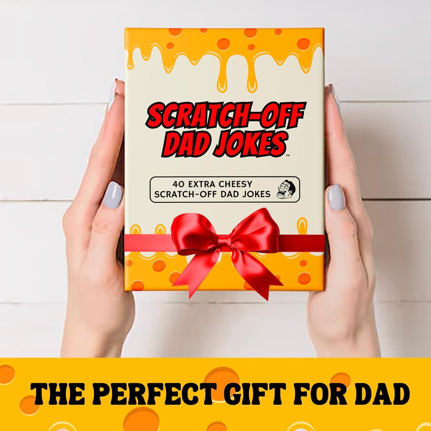 HighPeak Scratch Off Dad Jokes box with 40 extra cheesy dad joke cards and red bow held by hands on white background