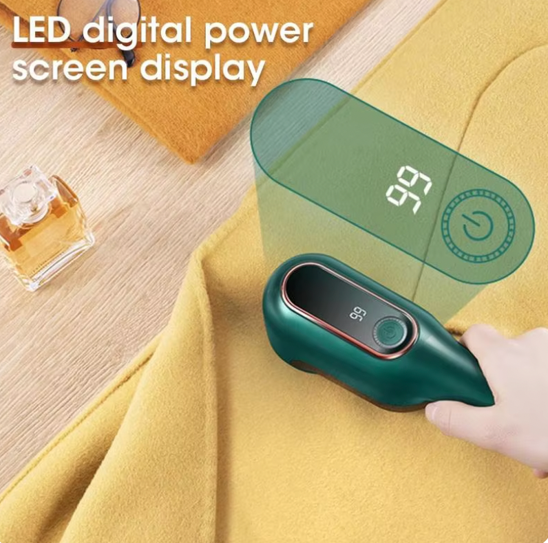 LintBuster Pro digital lint remover in green with LED display removing fuzz from yellow fabric - portable clothing cleaner