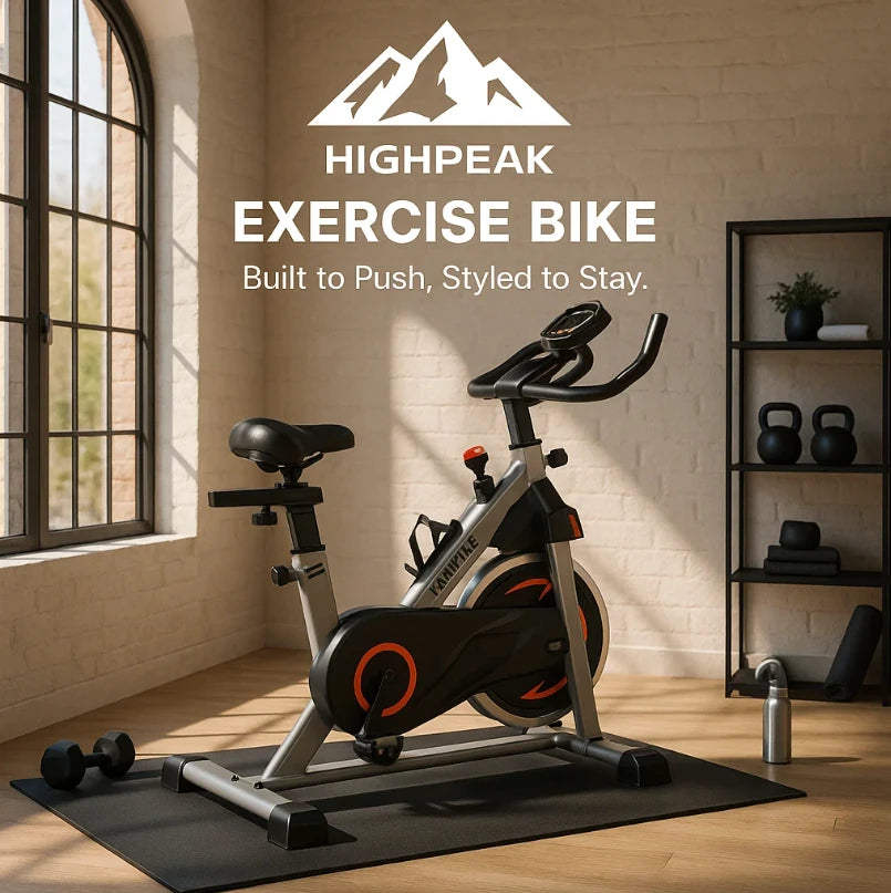HighPeak Exercise Bike in black and silver with adjustable seat, LCD display, and flywheel in a bright home gym setting