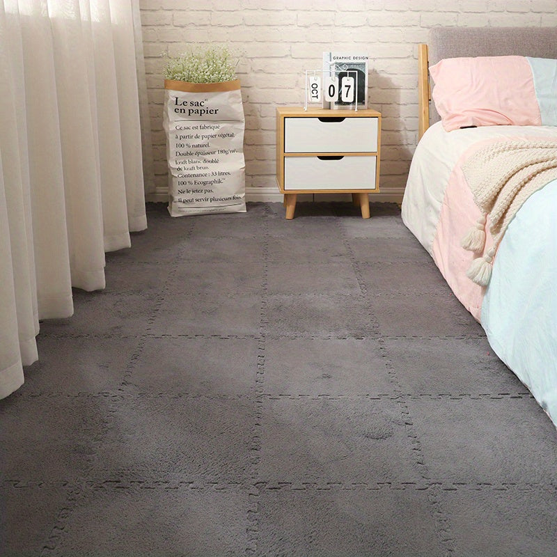 CozyTiles™ - 24pc Mat Set in gray plush tiles installed in bedroom with white nightstand and soft bedding by HighPeak