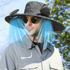 HighPeak Cooling Fan Sun Hat in gray worn outdoors with dual built-in fans providing breeze and sun protection