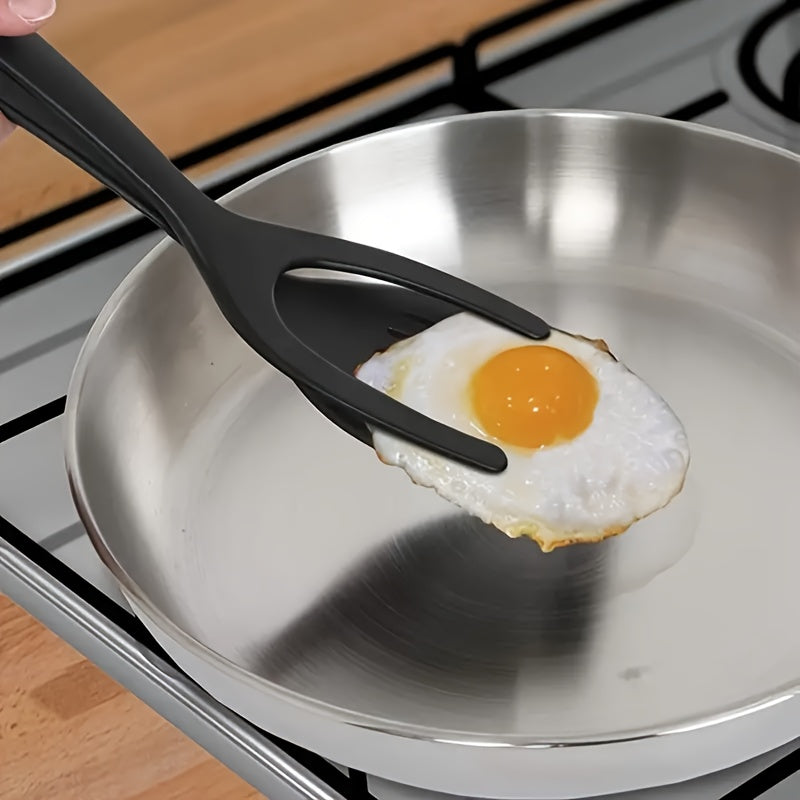 FlipGrip™ - 2 in 1 Spatula Tongs lifting a fried egg in a stainless steel pan on a stovetop for easy flipping