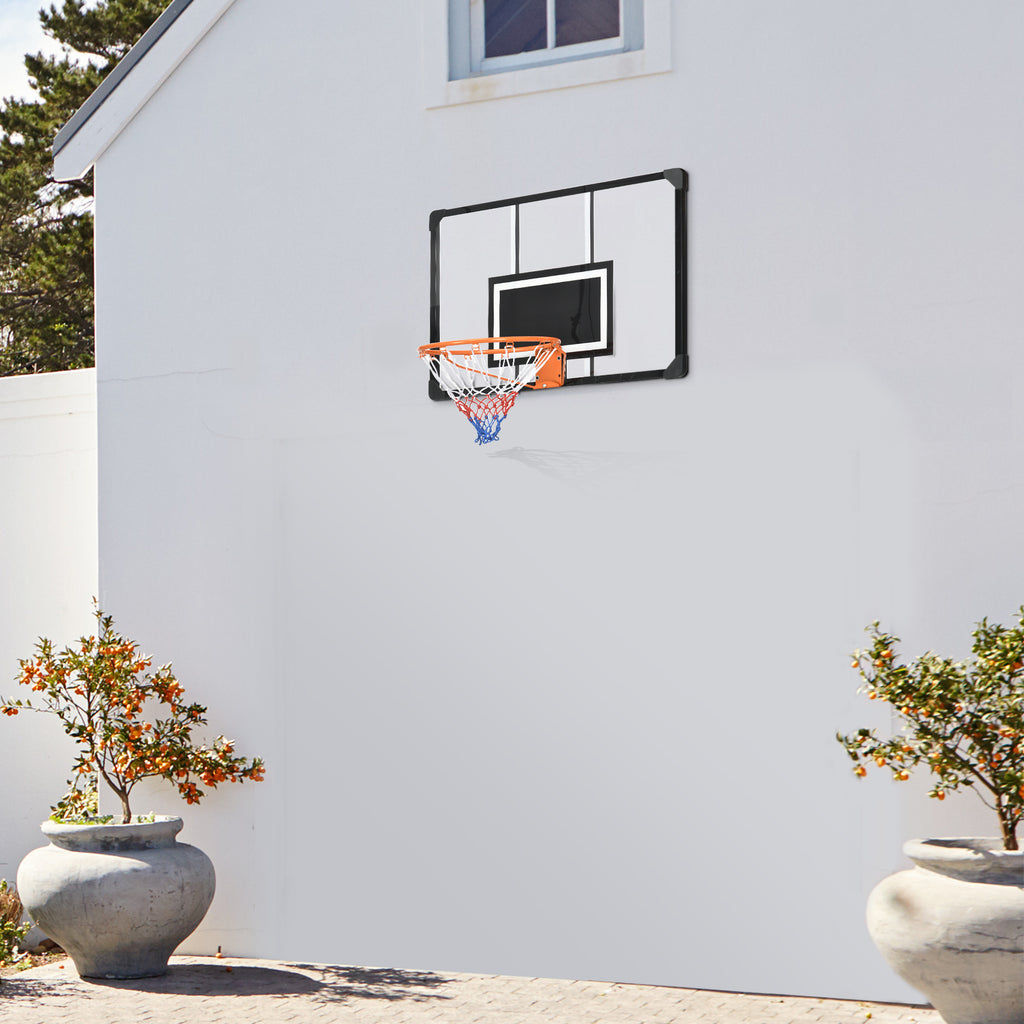 Mini basketball hoop mounted on a white wall with two potted plants in the foreground.