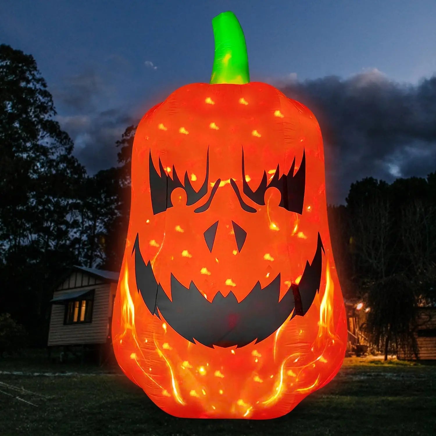 12FT Inflatable Jack-O’-Lantern glowing orange in a residential yard at dusk
