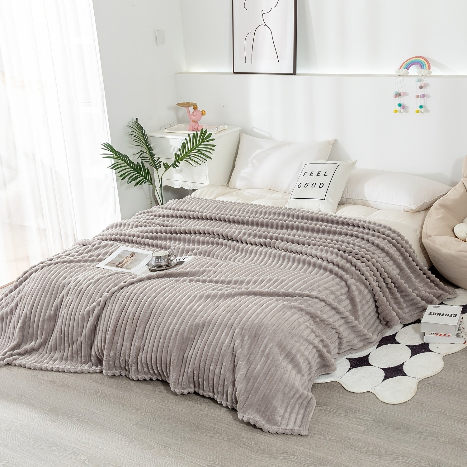 Ultra soft gray ribbed blanket draped over white bed with cozy flannel texture and plush faux fur finish