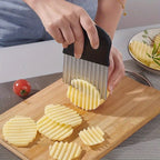 WaveBlade™ – Crinkle Cutter Knife with black handle slicing potatoes into wavy fries on a wooden cutting board