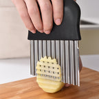 WaveBlade™ – Crinkle Cutter Knife with sharp stainless steel wavy blade and black handle slicing a potato on a wood board by HighPeak