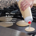 HighPeak FlipFlow™ - Batter Dispenser pouring pancake batter through red spout onto griddle in kitchen setting
