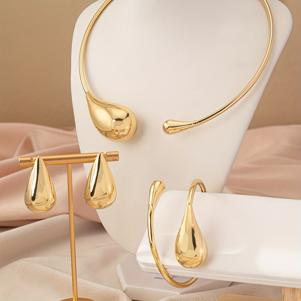 HighPeak Teardrop Jewelry Set in polished gold with necklace, bracelet, and earrings displayed on beige fabric background