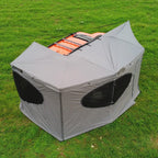 270° Vehicle Awning Tent in gray, shown from above with enclosed walls around an orange vehicle.