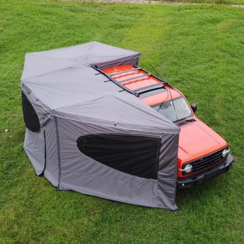 270° Vehicle Awning Tent extending around the side and rear of an orange vehicle on grass.