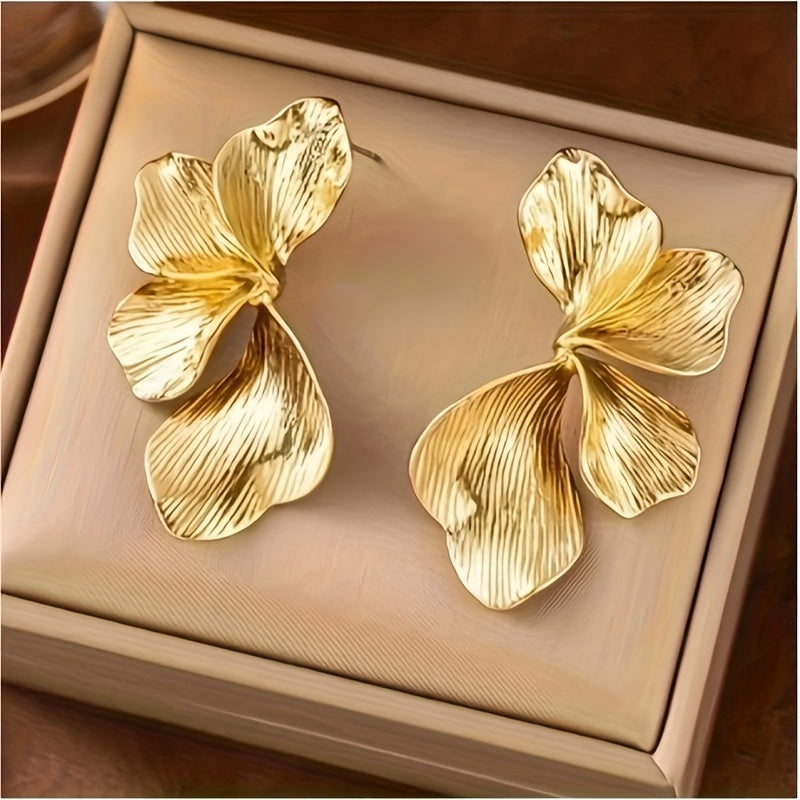HighPeak Exaggerated Petal Earrings in textured gold copper with bold 3D petals on a soft beige display box