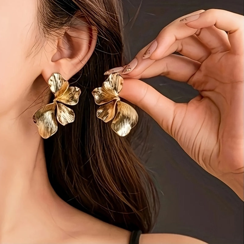 HighPeak Exaggerated Petal Earrings in textured copper worn by woman showing lightweight sculptural design