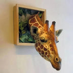 3D Giraffe Wall Sculpture on a light wall, showing its face and leafy frame from an angled view.