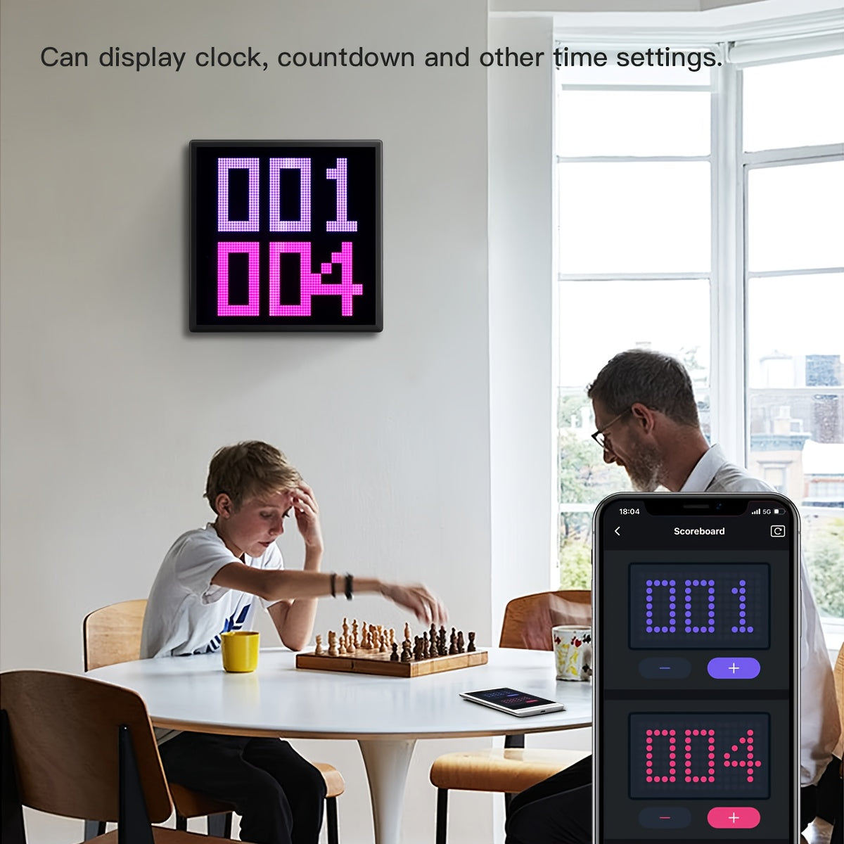 PixelPlay™ Smart LED Frame in black displays digital scores in pink and purple above a chess game, app-controlled in a bright room.