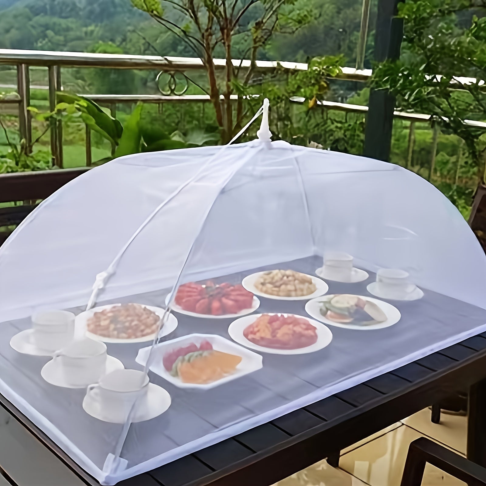 HighPeak Food Tent Cover in white mesh pop-up design protecting outdoor meal plates on a black table in garden setting