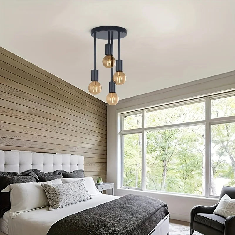 4-Light Ceiling Fixture in black installed above a modern bedroom with four exposed bulbs