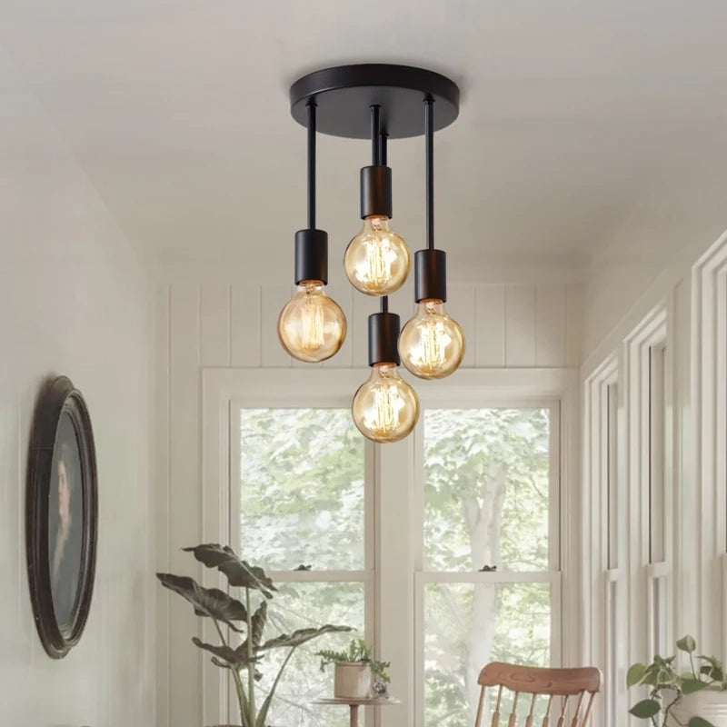 4-Light Ceiling Fixture in black installed in a bright sunroom with four warm exposed bulbs