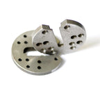 Close view of two overlapping metal body tilt components with mounting holes