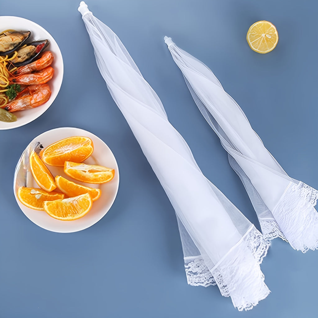 HighPeak Food Tent Cover in white mesh with lace trim, folded beside plates of seafood and orange slices on blue table