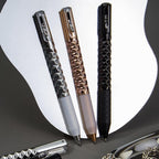 Geometric Metal Crinkle Pen in silver, gold, and black with textured diamond pattern design on white background