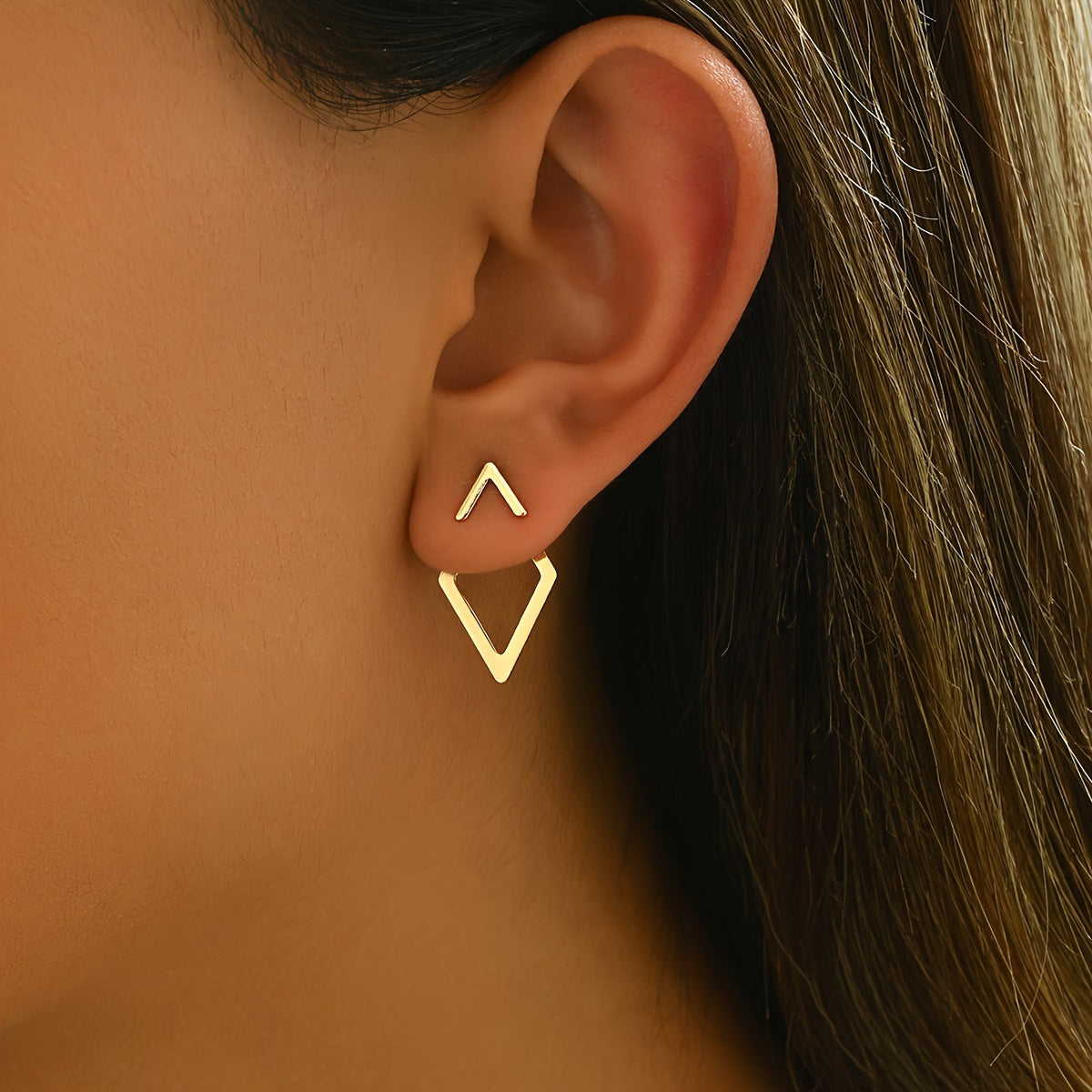 HighPeak Geometric Gold Earrings featuring gold-plated triangle studs worn on an ear, minimalist and bold style.