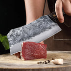 7-Inch Cleaver Chef Knife held above a boneless cut of beef on a wooden chopping board.