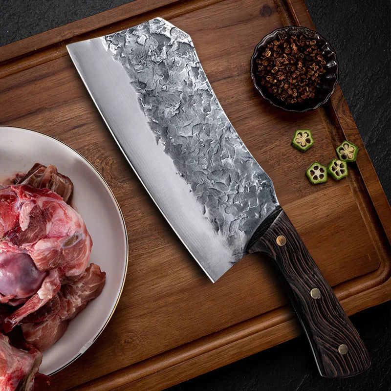7-Inch Cleaver Chef Knife on a wooden board beside a plate of meat, peppercorns, and sliced okra.