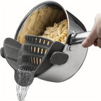SnapStrain™ clip on food strainer in gray attached to pot draining pasta with water pouring out, HighPeak kitchen tool