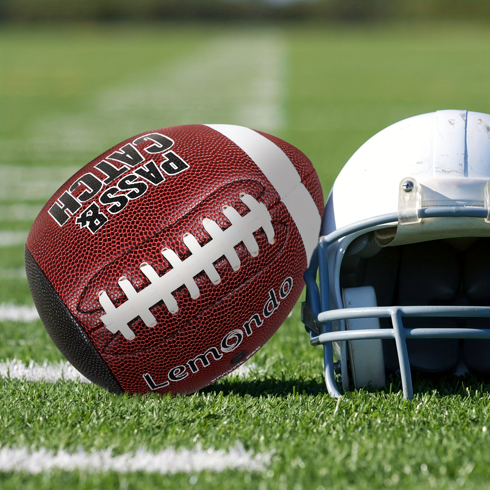 GripEgg™ Trainer – PASS & CATCH Edition on turf next to white football helmet, designed for grip and accuracy training