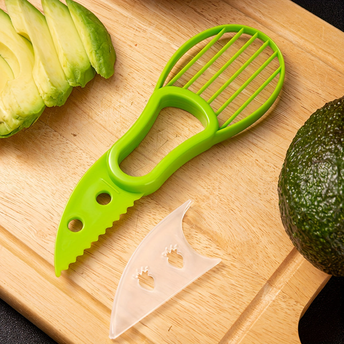 HighPeak Avocado Slicer in green with sharp blade, pitter grip, and multi-slicer head on wooden cutting board with avocado slices