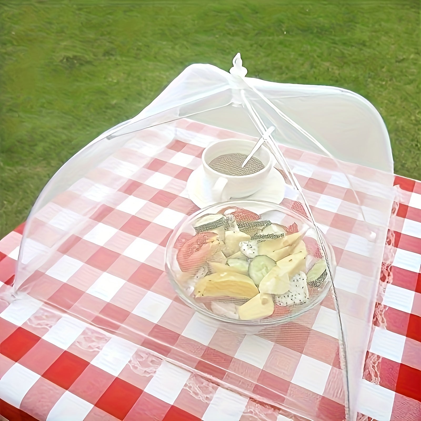 HighPeak Food Tent Cover in white mesh over fruit bowl and cup on red checkered picnic table outdoors