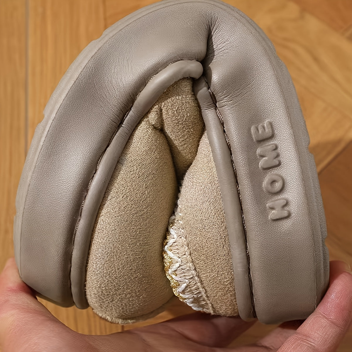 HighPeak CozyGlide plush slipper in beige with fleece lining and cushioned sole on wooden floor - cozy home comfort