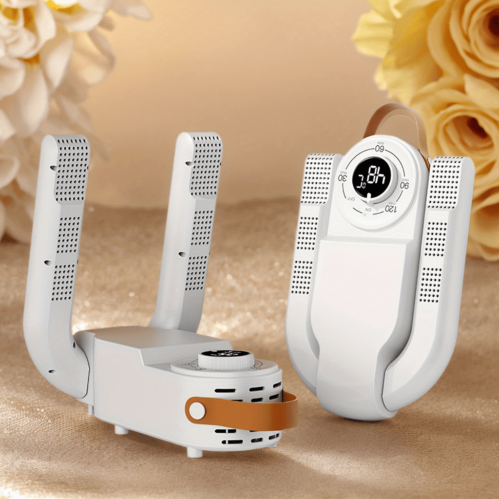 ShoeJet™ shoe dryer in white with foldable arms and smart heat control, displayed on a beige surface with flowers.