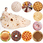A person wrapped in a HighPeak Food Blanket designed like a tortilla with realistic brown spots, demonstrating cozy burrito-style comfort