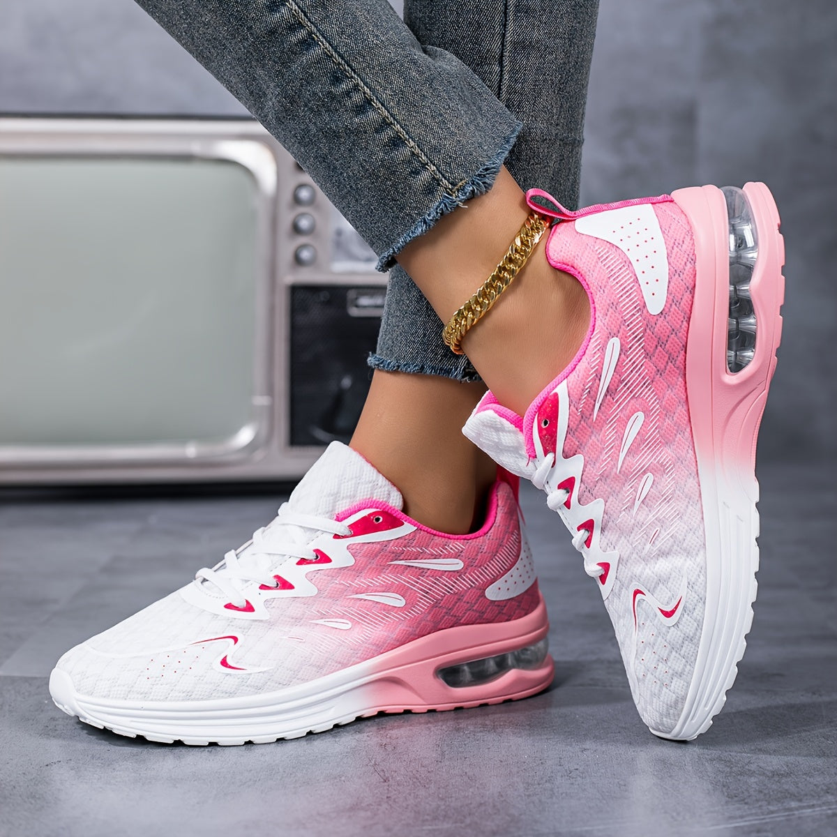 Air-Cushion Gradient Sneakers in pink-to-white ombre design with mesh upper and air-cushioned sole, styled with jeans