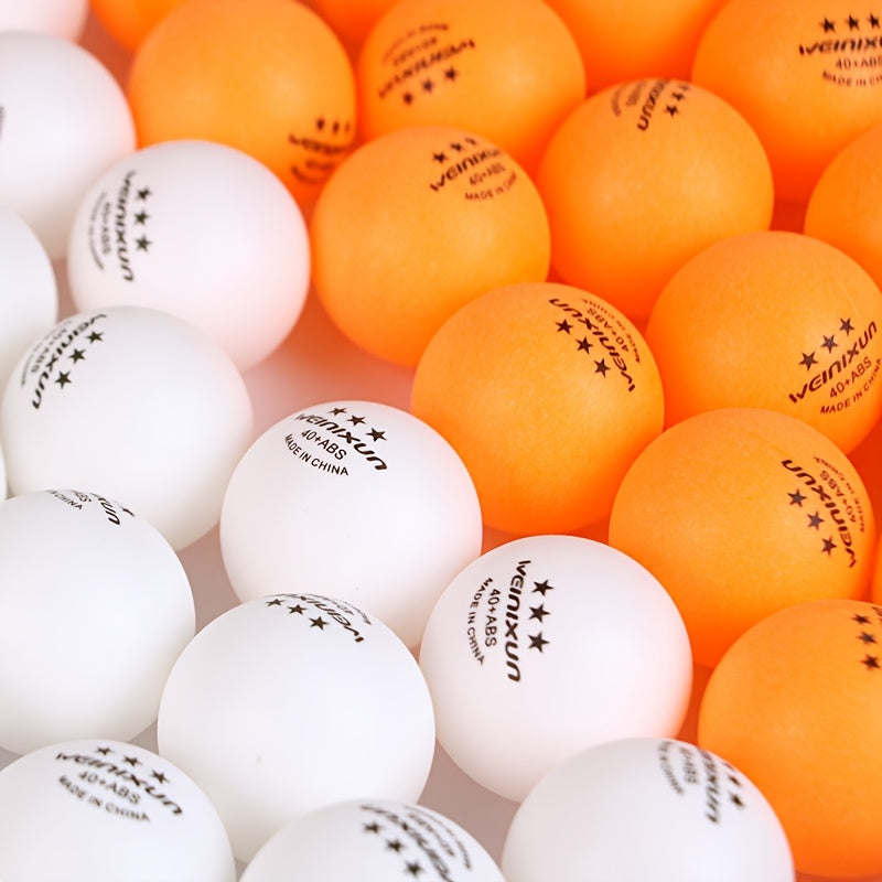 Bulk set of 100 orange and white ping pong balls stacked in pyramid