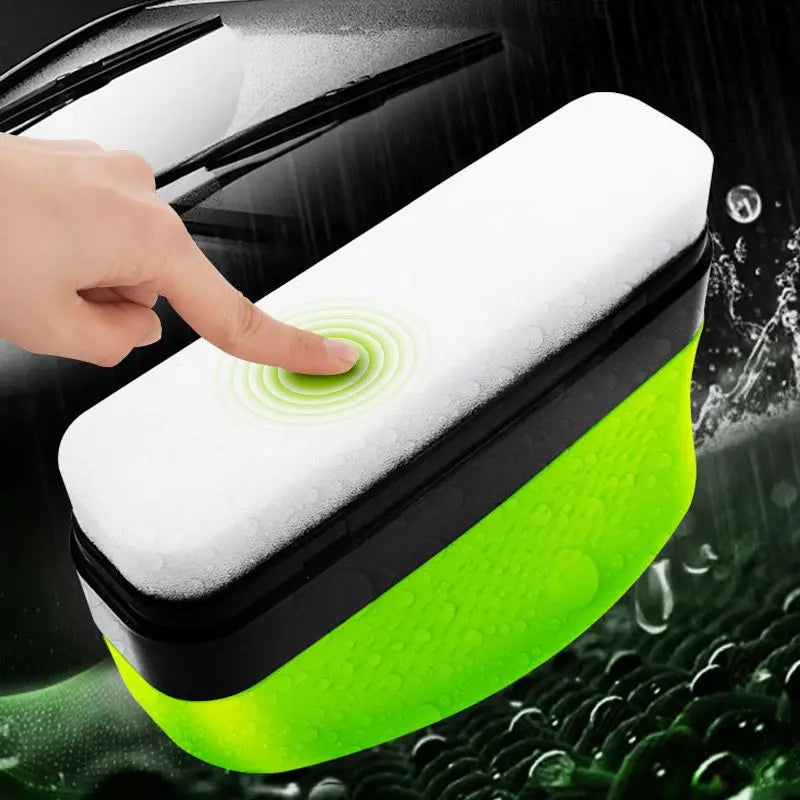 ClearVision windshield cleaner with white sponge and neon green ergonomic handle demonstrating cleaning action on glass surface