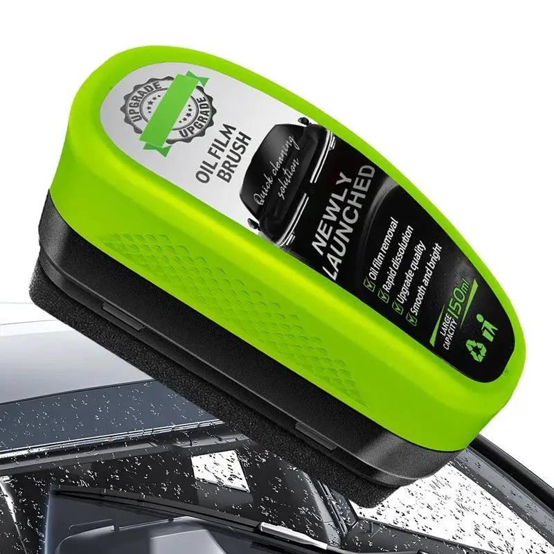 ClearVision windshield oil film remover with neon green ergonomic handle and black applicator pad shown on car windshield