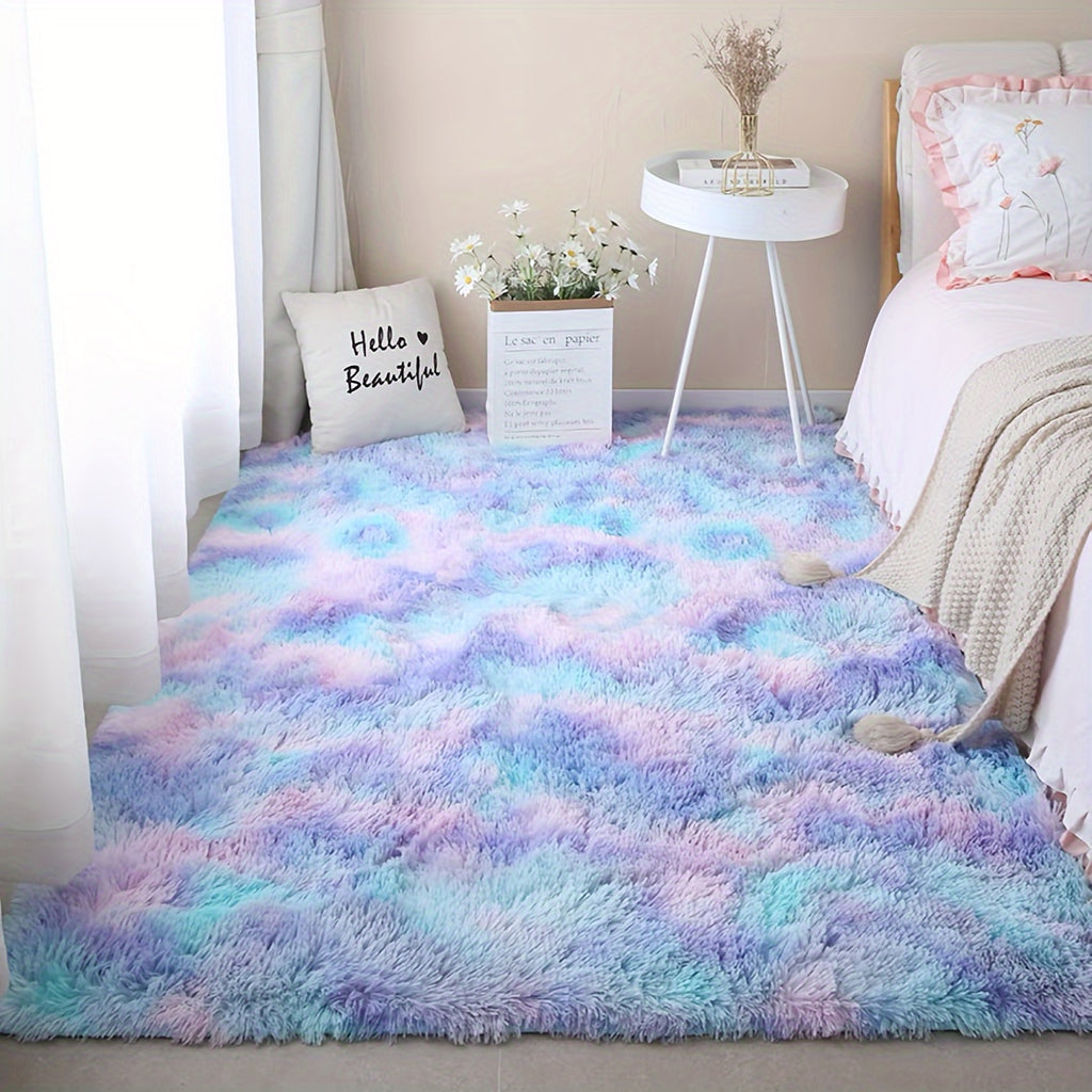 CloudCotton™ Rug in pastel rainbow gradient displayed in cozy bedroom setting with white side table and decorative elements
