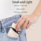 Compact pink Mini Pocket Umbrella being placed in denim jeans pocket, demonstrating portable size and easy storage