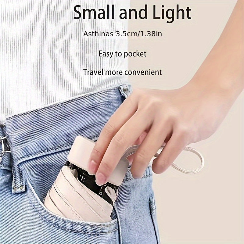 Compact pink Mini Pocket Umbrella being placed in denim jeans pocket, demonstrating portable size and easy storage