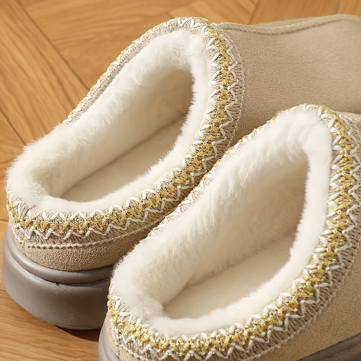 CozyGlide plush slippers in beige with white fleece lining and decorative gold trim, displayed on wooden flooring