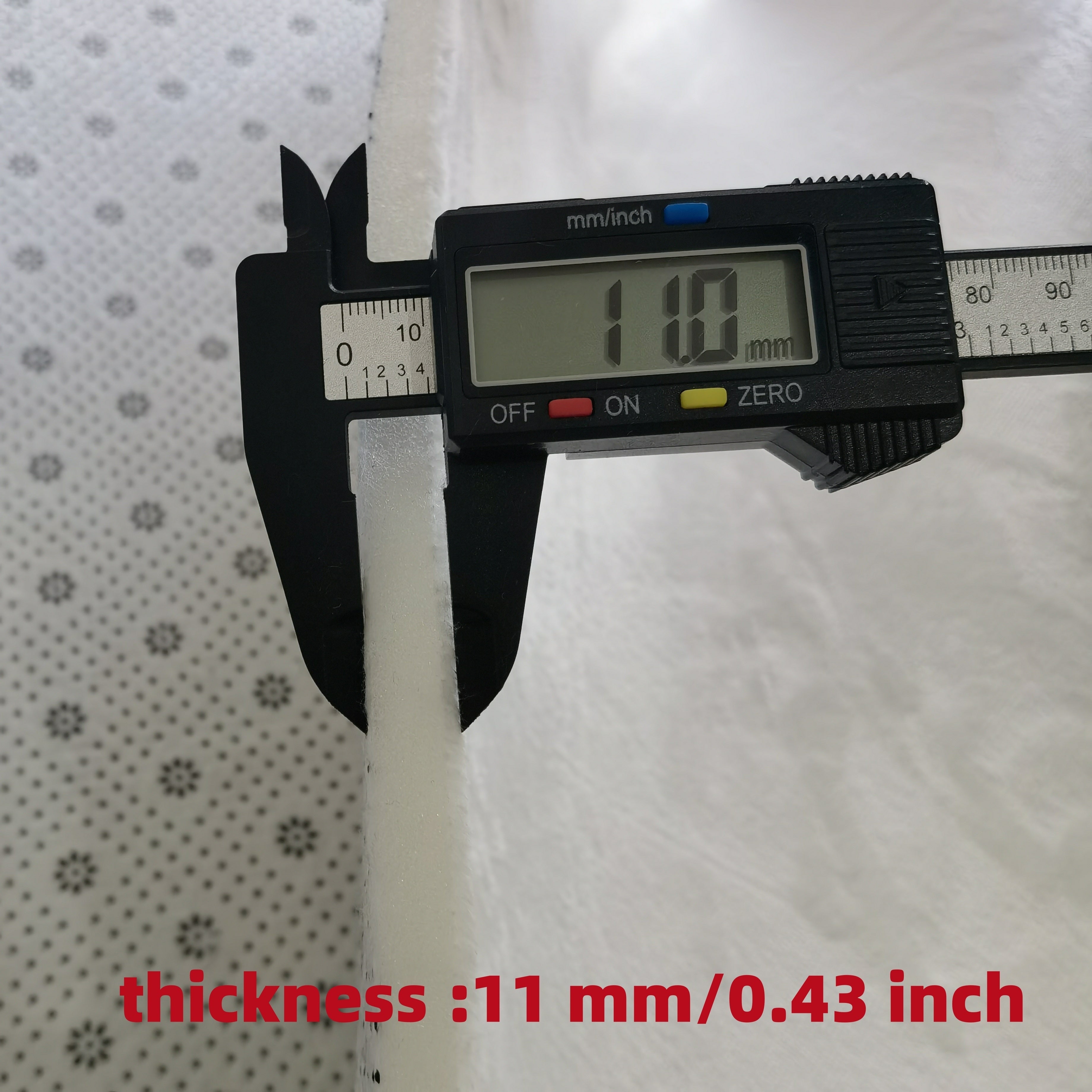 Digital caliper measuring Ocean Bliss Mat thickness at 11mm - showcasing comfort layer measurement
