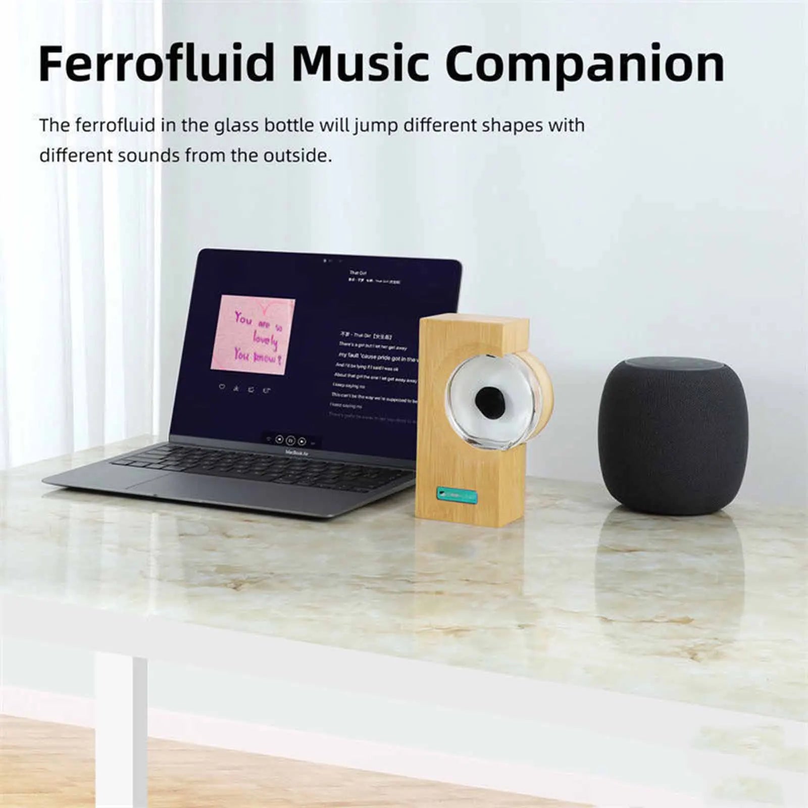 EchoFlow ferrofluid music visualizer with bamboo base and speaker on desk next to laptop - interactive sound display