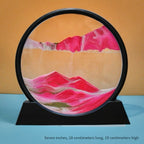 Eclipse Flow Dynamic Sand Art displaying pink sand formations against orange backdrop in circular black frame