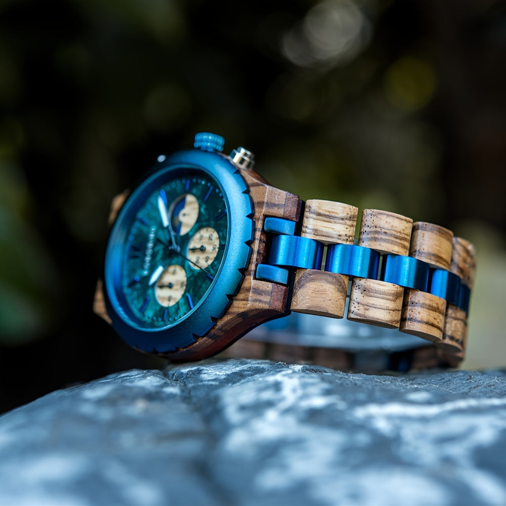 Engraved wooden watch with blue chronograph face and zebra wood band with metallic blue accents on stone surface