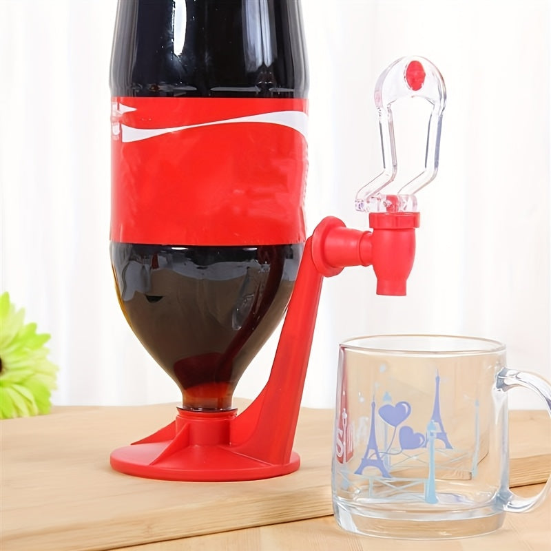 FizzFlow Soda Dispenser in bright red attached to cola bottle with clear tap spout, displayed on wooden surface near glass mug