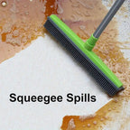 FurSweep Pro broom with green rubber head cleaning wet floor surface, demonstrating water and debris removal capability