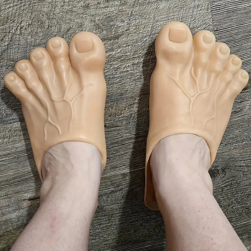 Giant Feet Slippers in beige with realistic toe details and textured design shown worn on grey surface